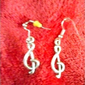 Pierced earrings. Music treble symbol in like new condition